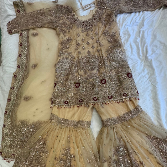 Mongas champagne, nude, gold gharara with red olive accents